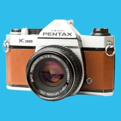 Pentax K1000 Brown Leather Vintage SLR 35mm Film Camera with Pentax f/2 50mm Prime Lens.