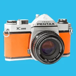Pentax K1000 Orange Leather Vintage SLR 35mm Film Camera with Pentax f/2 50mm Prime Lens.