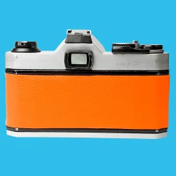 Pentax K1000 Orange Leather Vintage SLR 35mm Film Camera with Pentax f/2 50mm Prime Lens.