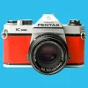 Pentax K1000 Red Leather Vintage SLR 35mm Film Camera with Pentax f/2 50mm Prime Lens.
