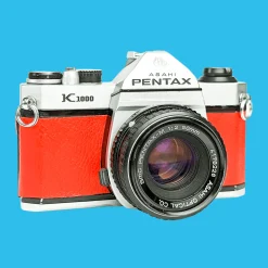Pentax K1000 Red Leather Vintage SLR 35mm Film Camera with Pentax f/2 50mm Prime Lens.