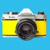 Pentax K1000 Yellow Leather Vintage SLR 35mm Film Camera with Pentax f/2 50mm Prime Lens.