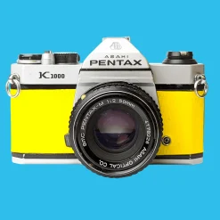 Pentax K1000 Yellow Leather Vintage SLR 35mm Film Camera with Pentax f/2 50mm Prime Lens.