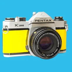 Pentax K1000 Yellow Leather Vintage SLR 35mm Film Camera with Pentax f/2 50mm Prime Lens.